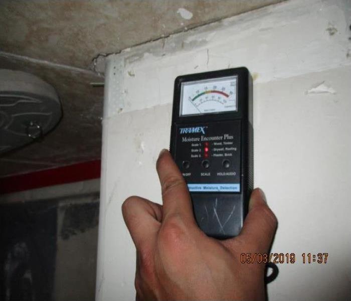 Photo of moisture meter on wall