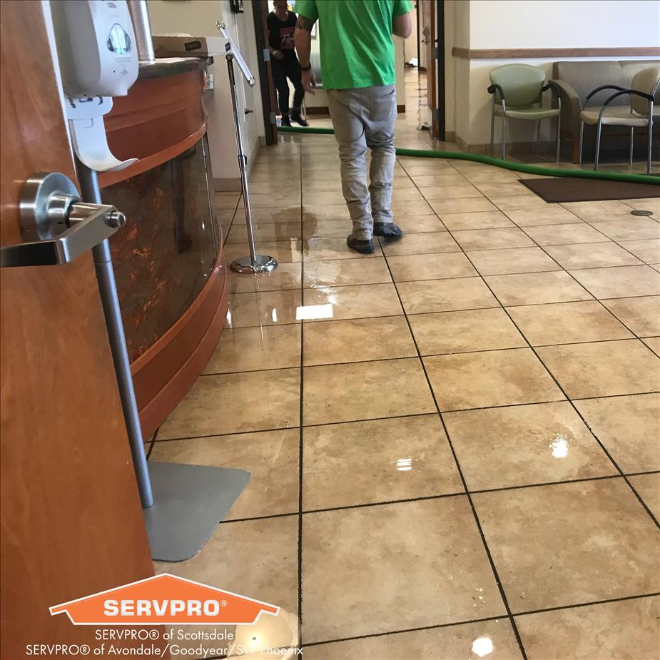 Picture of water in office building with SERVPRO crew
